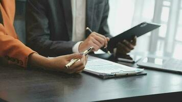 Financial analysts analyze business financial reports on a digital tablet planning investment project during a discussion at a meeting of corporate showing the results of their successful teamwork. video