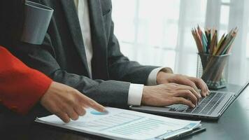 Financial analysts analyze business financial reports on a digital tablet planning investment project during a discussion at a meeting of corporate showing the results of their successful teamwork. video