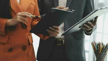 Financial analysts analyze business financial reports on a digital tablet planning investment project during a discussion at a meeting of corporate showing the results of their successful teamwork. video