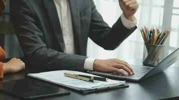 Financial analysts analyze business financial reports on a digital tablet planning investment project during a discussion at a meeting of corporate showing the results of their successful teamwork. video