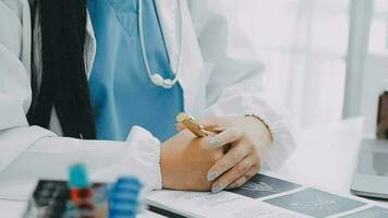 Team of doctors and businesswoman having a meeting in medical office video