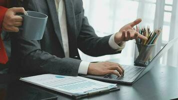 Financial analysts analyze business financial reports on a digital tablet planning investment project during a discussion at a meeting of corporate showing the results of their successful teamwork. video