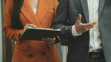 Financial analysts analyze business financial reports on a digital tablet planning investment project during a discussion at a meeting of corporate showing the results of their successful teamwork. video