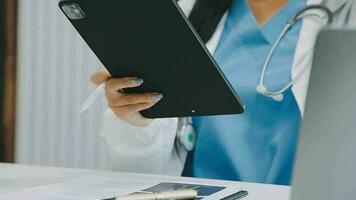 Team of doctors and businesswoman having a meeting in medical office video