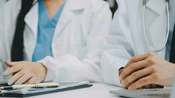 Team of doctors and businesswoman having a meeting in medical office video