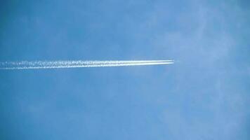 Aircraft flying by high in the sky with a thick contrail behind it video