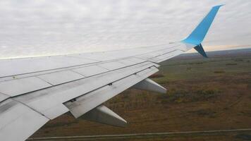 Passenger flight departure, POV view. Aircraft porthole and wing, first person view during takeoff or landing video
