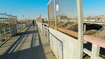 Pedestrian bridge over the railway. Walking POV pedestrian footbridge over railway tracks, railway station, Russia. video