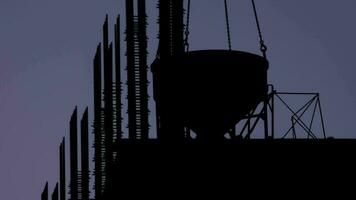 Silhouette of crane on the rooftop of a residential building under construction in a course of building video