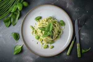 Traditional Italian spaghetti with asparagus in a herb sauce served as a top view on a Nordic design plate, generate ai photo