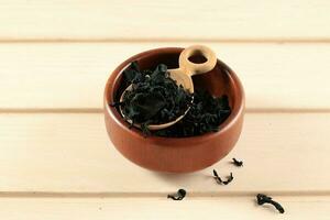 Dried Seaweed Wakame in Wooden Spoon photo