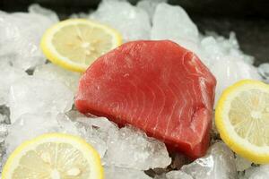 Fresh Raw Tuna Steak with Lemon and Ice. photo