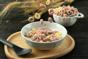 Colored Fruit Grain Loops on A Bowl of Milk photo