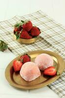 Japanese Mochi Strawberry on Gold Oval Plate. photo
