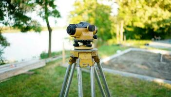 Surveyor equipment theodolite on the construction site. Land surveying with optical measurement tools. Theodolite on the site. Measurement on construction site. photo