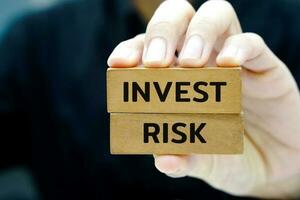 Businessman holding a wooden block with text. Risk management, strategic, insurance and business plan concept. photo