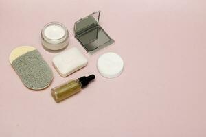 cosmetic accessories on pink background with copy space photo