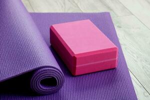 gymnastic mat with yoga brick, sports at home photo