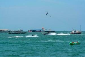 PATTAYA, THAILAND - December 31, 2022 Pattaya beach is crowded with many tourists. After opening Thailand, opening the country to welcome foreign tourists. after the COVID situation unfolds photo