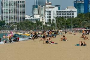 PATTAYA, THAILAND - December 31, 2022 Pattaya beach is crowded with many tourists. After opening Thailand, opening the country to welcome foreign tourists. after the COVID situation unfolds photo