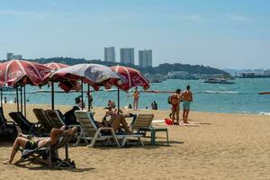 PATTAYA, THAILAND - December 31, 2022 Pattaya beach is crowded with many tourists. After opening Thailand, opening the country to welcome foreign tourists. after the COVID situation unfolds photo