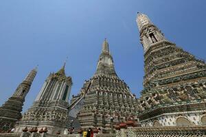 Wat Arun, seen from the bottom up, sees the blue sky. Wat Arun is an iconic landmark of Bangkok, Thailand. photo