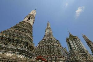 Wat Arun, seen from the bottom up, sees the blue sky. Wat Arun is an iconic landmark of Bangkok, Thailand. photo