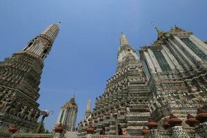 Wat Arun, seen from the bottom up, sees the blue sky. Wat Arun is an iconic landmark of Bangkok, Thailand. photo