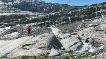 Caucasian Hiker on Glacial Valley Trail. Scenic Norwegian Hiking. video