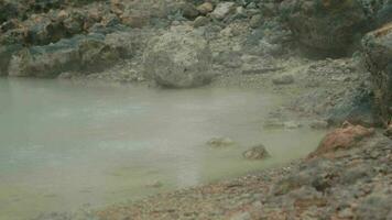 a volcanic crater filled with hot sulfur water and rocks video