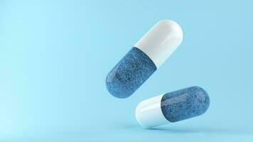 Blue capsule on blue background. Health and medical concept. photo