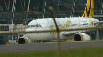 PHUKET, THAILAND NOVEMBER 27, 2017 - Airbus A319 132, 9V TRB of Scoot taxi from the terminal to the runway strat for departure from Phuket International Airport HKT. video