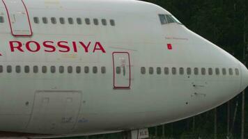 MOSCOW, RUSSIAN FEDERATION JULY 28, 2021 - Passenger Boeing 747 Rossiya rides on taxiway at Sheremetyevo Airport, Moscow SVO. Huge double deck passenger Boeing on the airfield, close up video