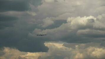 Airplane take off, climb in the dark stormy sky. Departing plane, rear view video