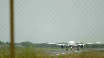 Passenger flight departing. Front view through airport fence of widebody passenger plane taking off. Tourism and travel concept video