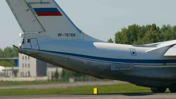 NOVOSIBIRSK, RUSSIAN FEDERATION JUNY 12, 2022 - Side view of transport aircraft IL 76 on the runway at Tolmachevo airport. Il 76 Soviet heavy military transport aircraft video