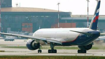 MOSCOW, RUSSIAN FEDERATION JULY 29, 2021 - Aeroflot Airlines Boeing 777 taxiing on runway at Sheremetyevo International Airport, Moscow SVO. Air travel, travel concept. Airplane, close up video