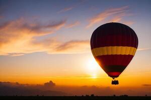 Hot air balloon in the sky with beautiful clouds at sunset background. photo