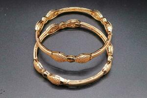 Women gold bangles with black background,bangles design photo