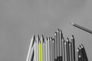 Black and white picture of pencils color. But there are someting that are colored. photo