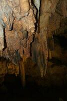 interesting original cave in the Turkish mountains with stalactites and stalagmites creating the background photo