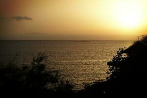 picturesque ocean landscape with the setting sun in a tropical country during summer holidays photo