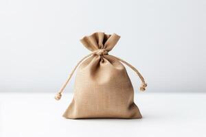 tiny money bag, isolated, minimalistic, high angle view, light background. photo