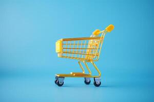yellow shopping cart on blue background. photo
