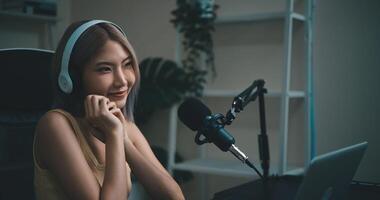 Cheerful Young podcaster use microphone during online podcast in studio photo