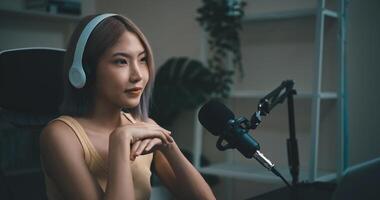 Cheerful Young podcaster use microphone during online podcast in studio photo