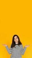 Visual of Assertive Woman. Attractive Lady Displaying 'No Answer' Gesture with Both Hands - Nonverbal Communication Concept Isolated on Bright Yellow Background photo