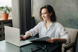 Flexible Work and Study. Young Woman Using Laptop at Office and Student Girl Working from Home. Freelancing, Business, and Lifestyle Concept. photo