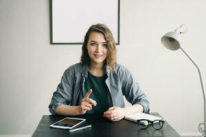 Young Businesswoman Conducting a Video Conference from Office or Home, Engaged and Confident, Demonstrating Life Coaching and Online Business Meeting Concept. Technology Communication in Modern Work photo
