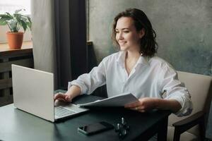 Flexible Work and Study. Young Woman Using Laptop at Office and Student Girl Working from Home. Freelancing, Business, and Lifestyle Concept. photo